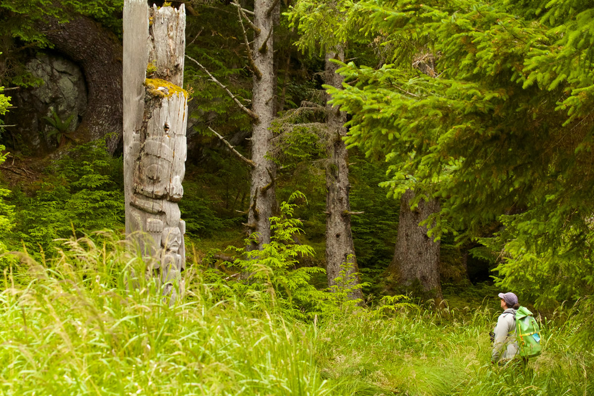 Standing beneath Haida mortuary pole in Sgang Gwaay